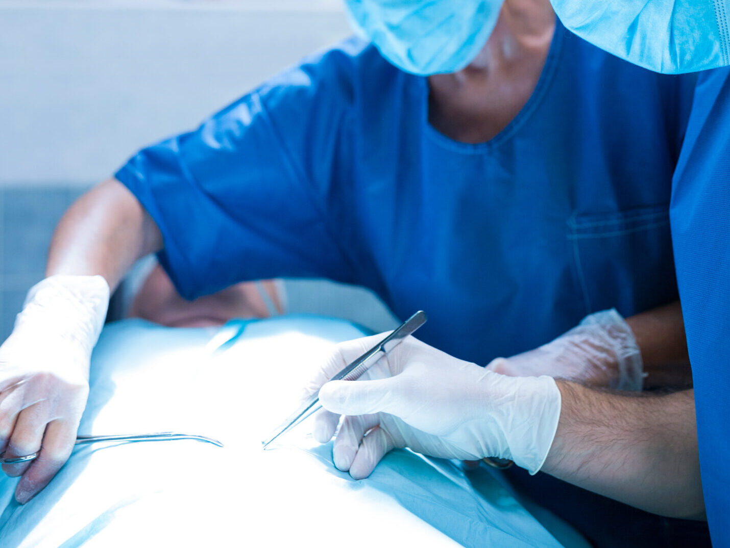 Surgeons performing operation in operation room at the hospital